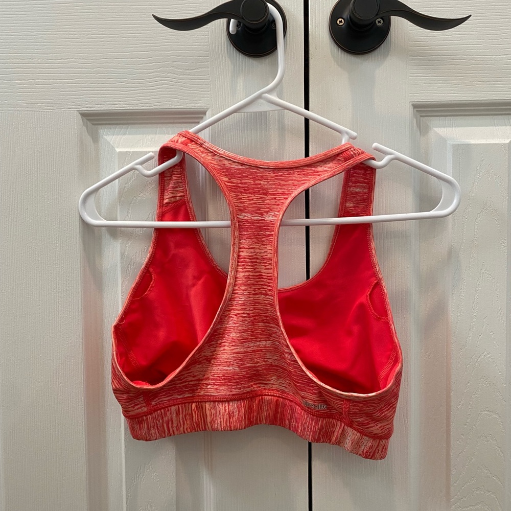 Adidas sports bra size medium. In a coral color place for inserts or padding.